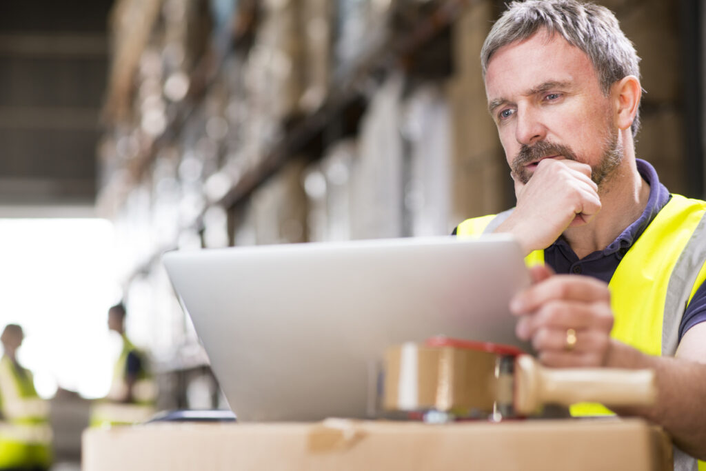 A tradie business owner in workwear reviewing a strategic exit planning checklist