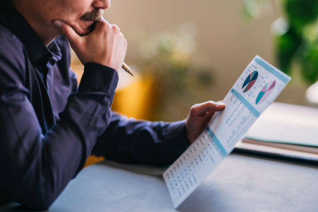 Australian tradesperson conducting a quarterly cashflow health check on a laptop to review business finances and profitability.