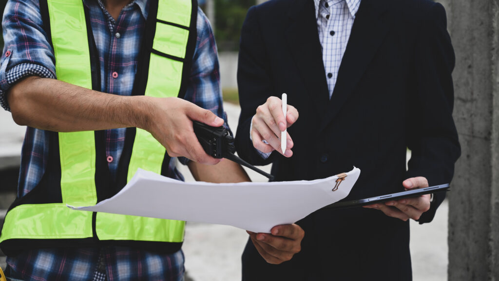 Australian trade business owner discussing contractor terms and compliance on a job site.
